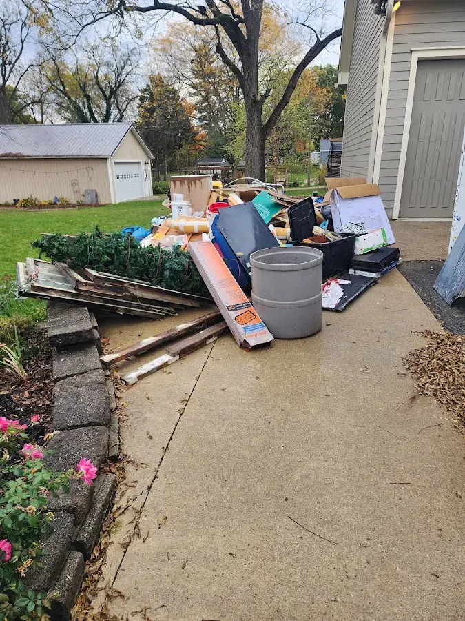 Dumpster being loaded with debris for 3 Yard Dumpster Rental in El Dorado Springs